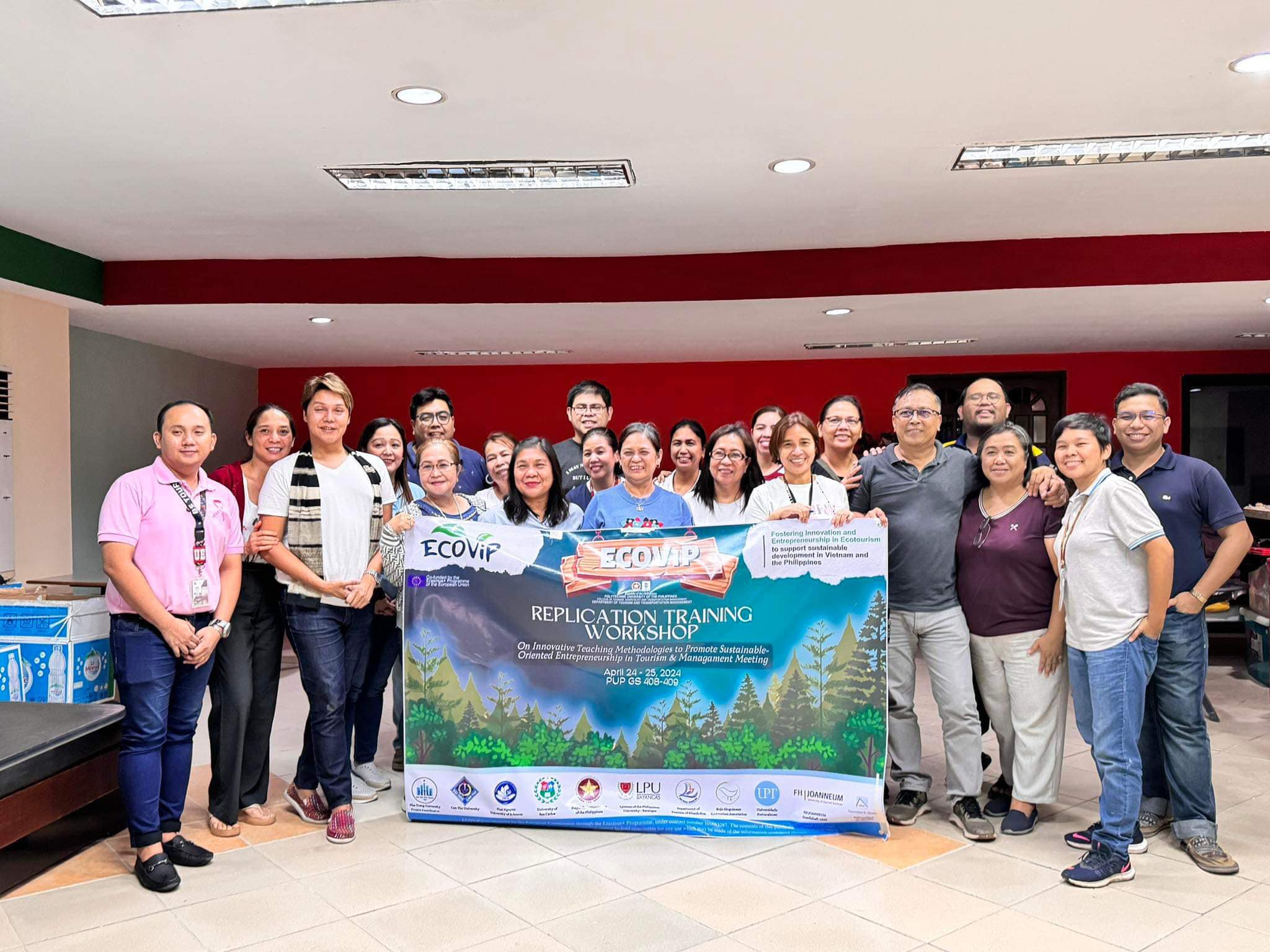 PUP faculty members holding an ECOVIP tarpaulin