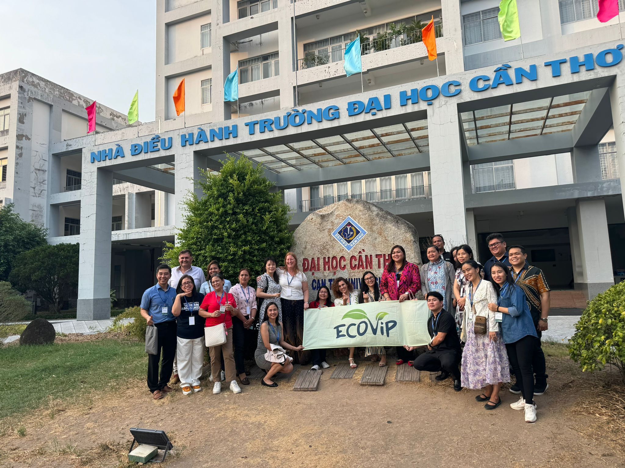 Participants posing in front of Can Tho University sign with ECOVIP flag