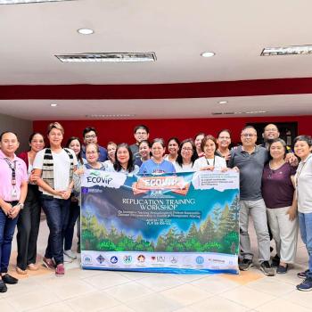 PUP faculty members holding an ECOVIP tarpaulin