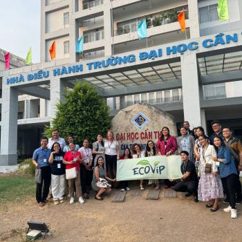 Participants posing in front of Can Tho University sign with ECOVIP flag